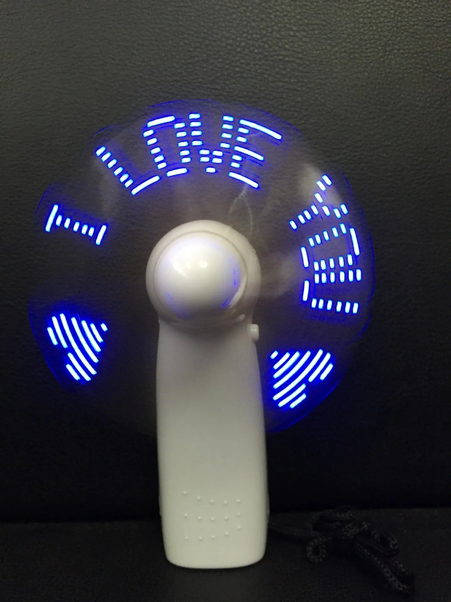 White handheld mini fan with flashing blue and red LED love pattern lights