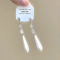 Alloy heart-shaped geometric ear clip with rhinestone detailing and star tassels