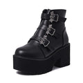 Black women's punk-style Martin ankle boots with a bat-shaped buckle and side zipper.