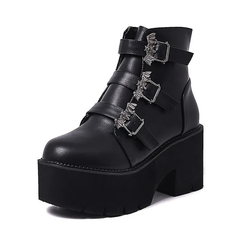 Black women's punk-style Martin ankle boots with a bat-shaped buckle and side zipper.