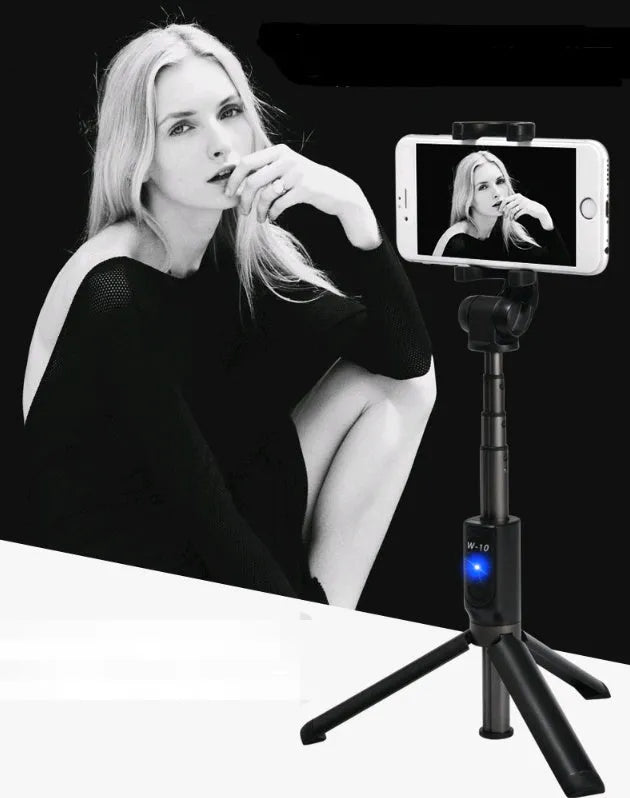 Aluminium Bluetooth selfie stick with tripod legs extended and wireless remote on a table