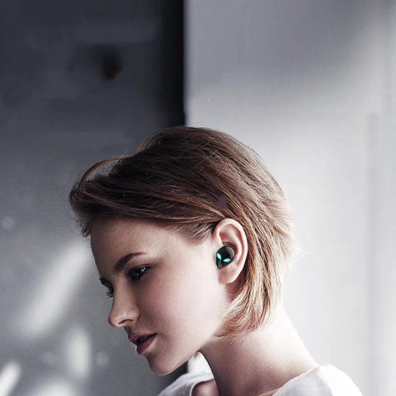 Creative Outer T8 Starman Alien design Bluetooth earbuds with red lighting in charging case.