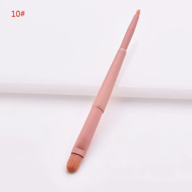 Ten professional makeup brushes with wooden handles arranged by size for different cosmetic applications