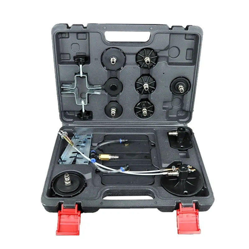 Pneumatic brake fluid replacement machine with large tank, pressure gauge, and regulator on a workshop bench.