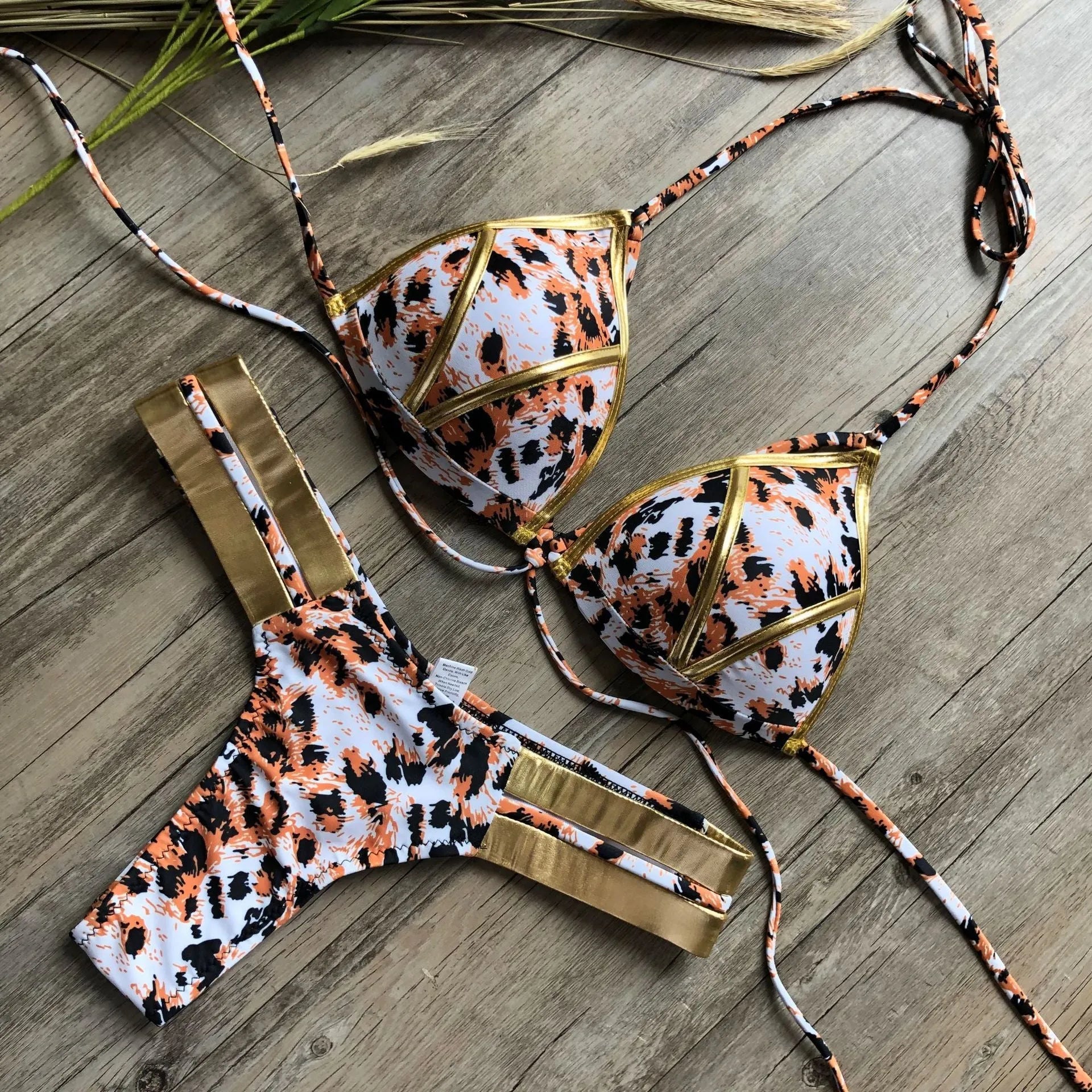 Women's bronzing bikini swimsuit with padded cups and cotton lining in multiple colour and print options.