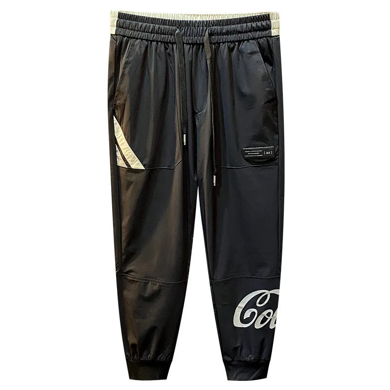 Men's black cropped casual trousers with an ankle band made from thin cotton fabric.