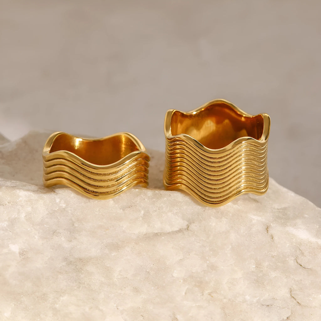 Geometric wide band stainless steel wave ring for women with electroplated finish.