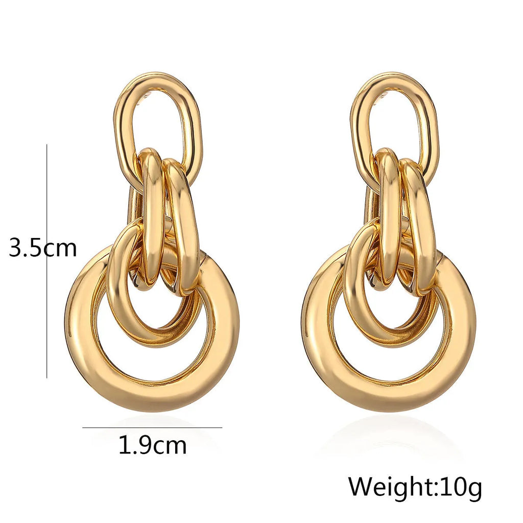 A pair of gold geometric earrings for women with an irregular shape, made from copper.