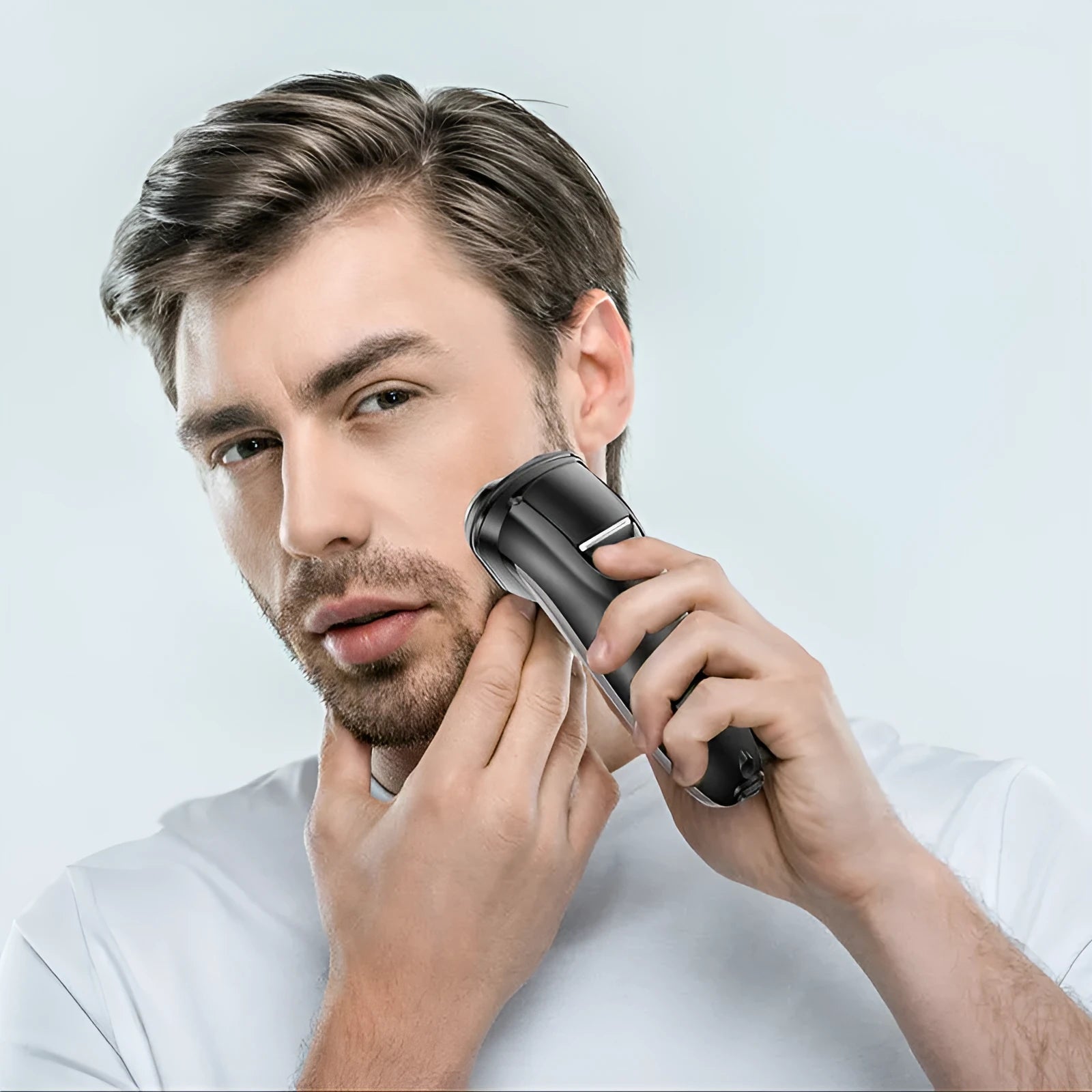 Men's electric shaver kit with three rotating cutter heads, USB charging cable, and pop-up sideburn trimmer
