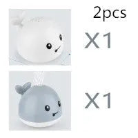 Blue and white whale bath toy with water spray and flashing lights for baby sensory play