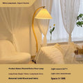 Vertical retro floor lamp with wood shade in three-colour variable light beside bed