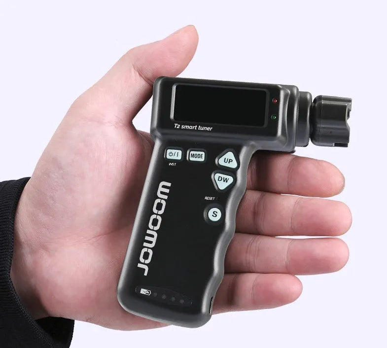 Black and white smart guitar tuner and string winder combo with LCD display and USB charging cable