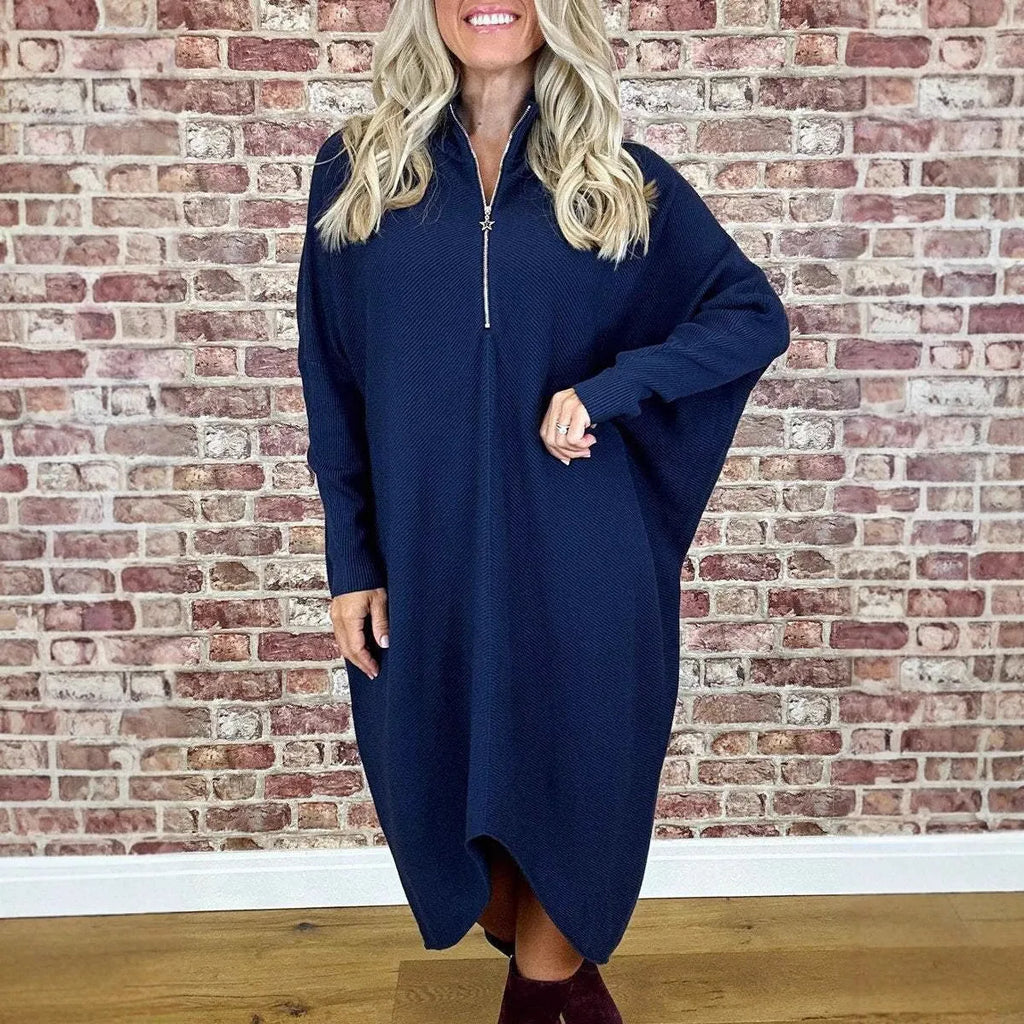 Women's solid colour loose knitted dress with raglan sleeves and a zipper detail.
