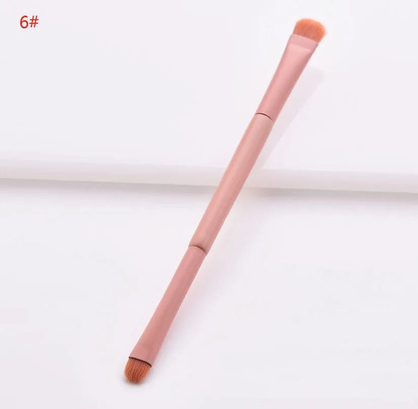 Ten professional makeup brushes with wooden handles arranged by size for different cosmetic applications