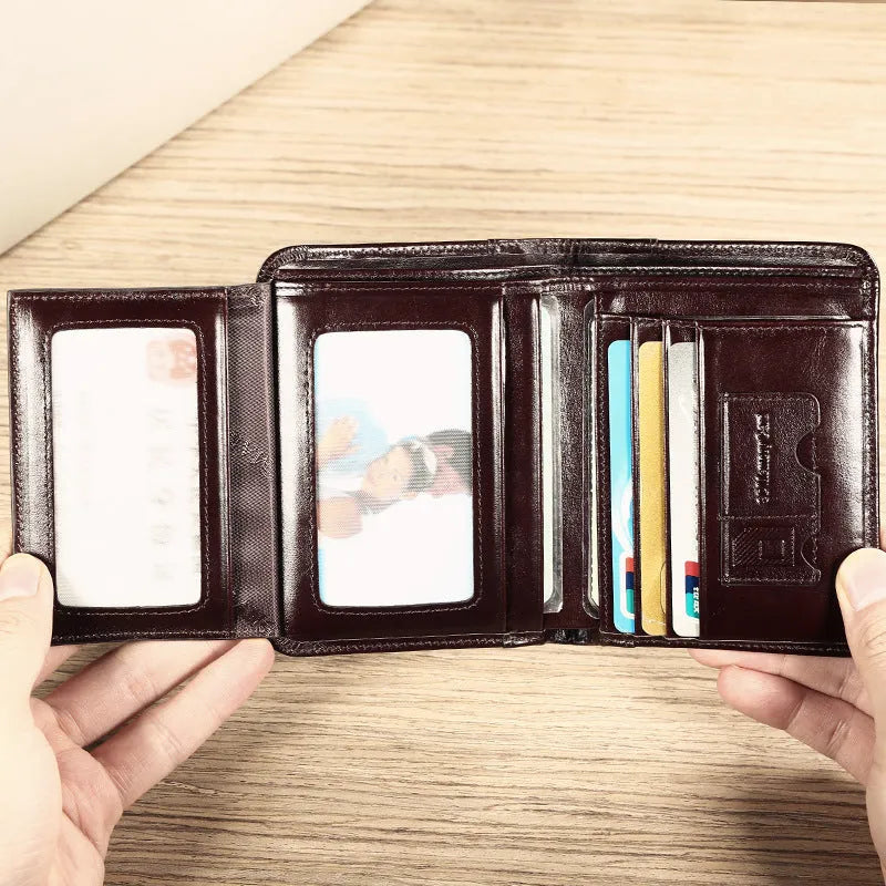 Men's compact leather wallet open showing card slots, change pouch, photo slot, and dark privacy compartment.