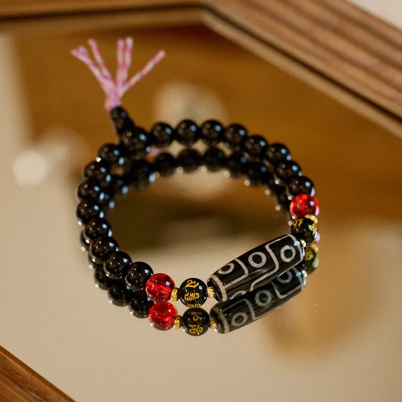 8mm agate Dzi bead bracelet with geometric shape and Tibetan-style beaded strap.