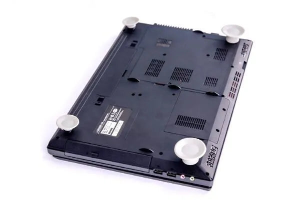 Set of four grey durable plastic laptop cooling pads: two large and two small, on a desk.