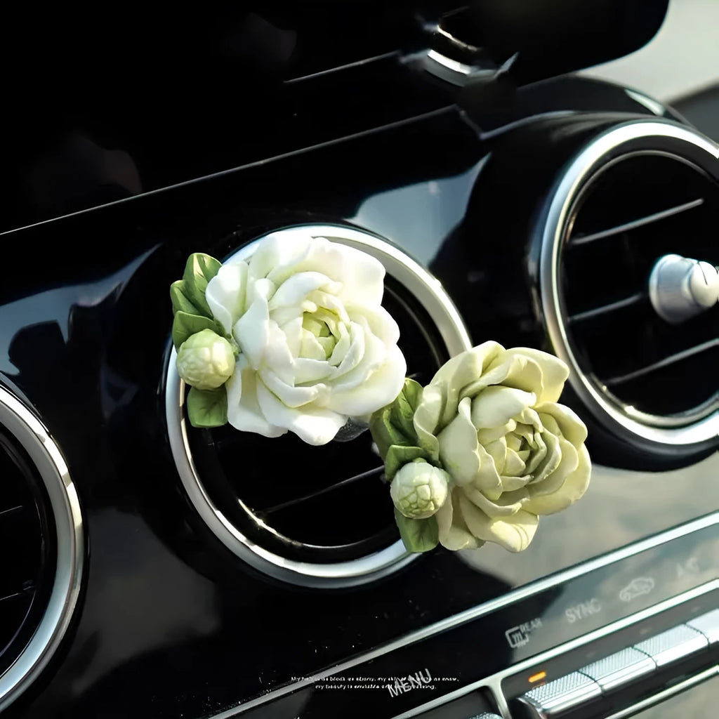 Solid gypsum car air freshener diffuser in air vent with jasmine fragrance oil.