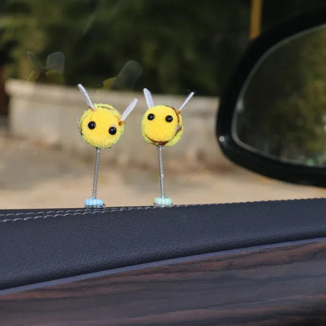Yellow and black cartoon bee car decoration made from fur ball material measuring 3x3cm