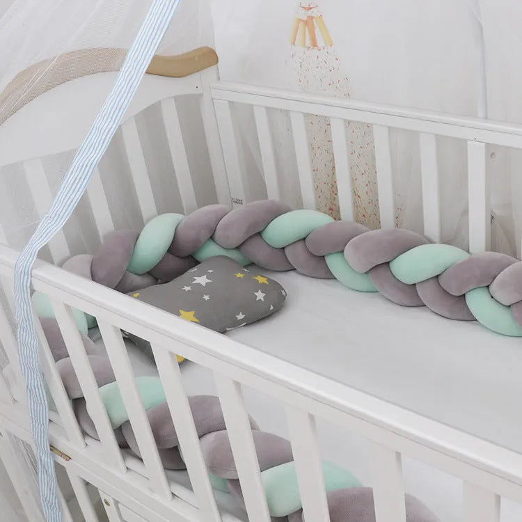 Multi-colour baby crib bumper made of spandex velvet, shown bent around a crib edge.