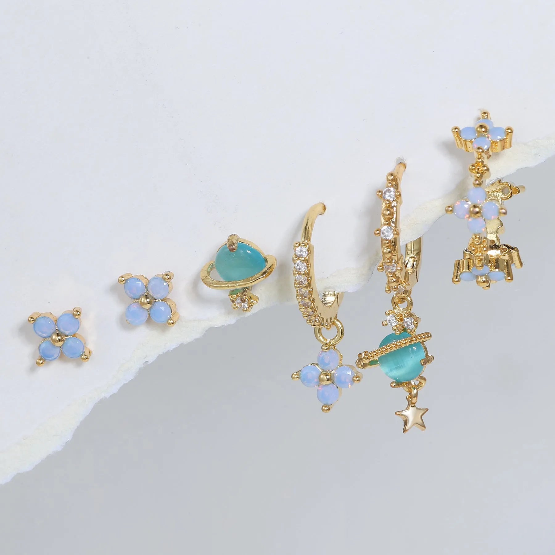 Gold and silver floral stud earrings with blue protein stone mosaic design.