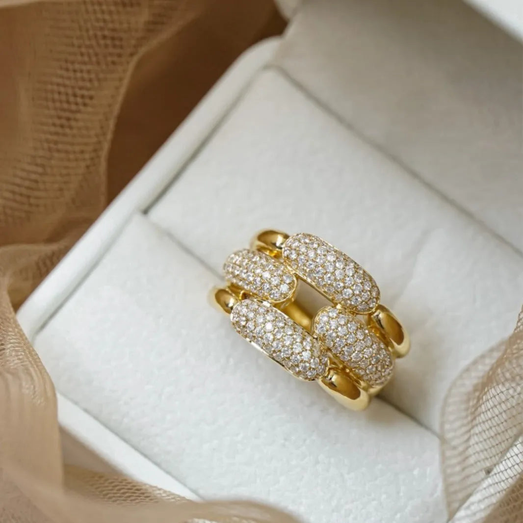 S925 sterling silver geometric ring for women with yellow gold finish and gang drill pattern on pink background