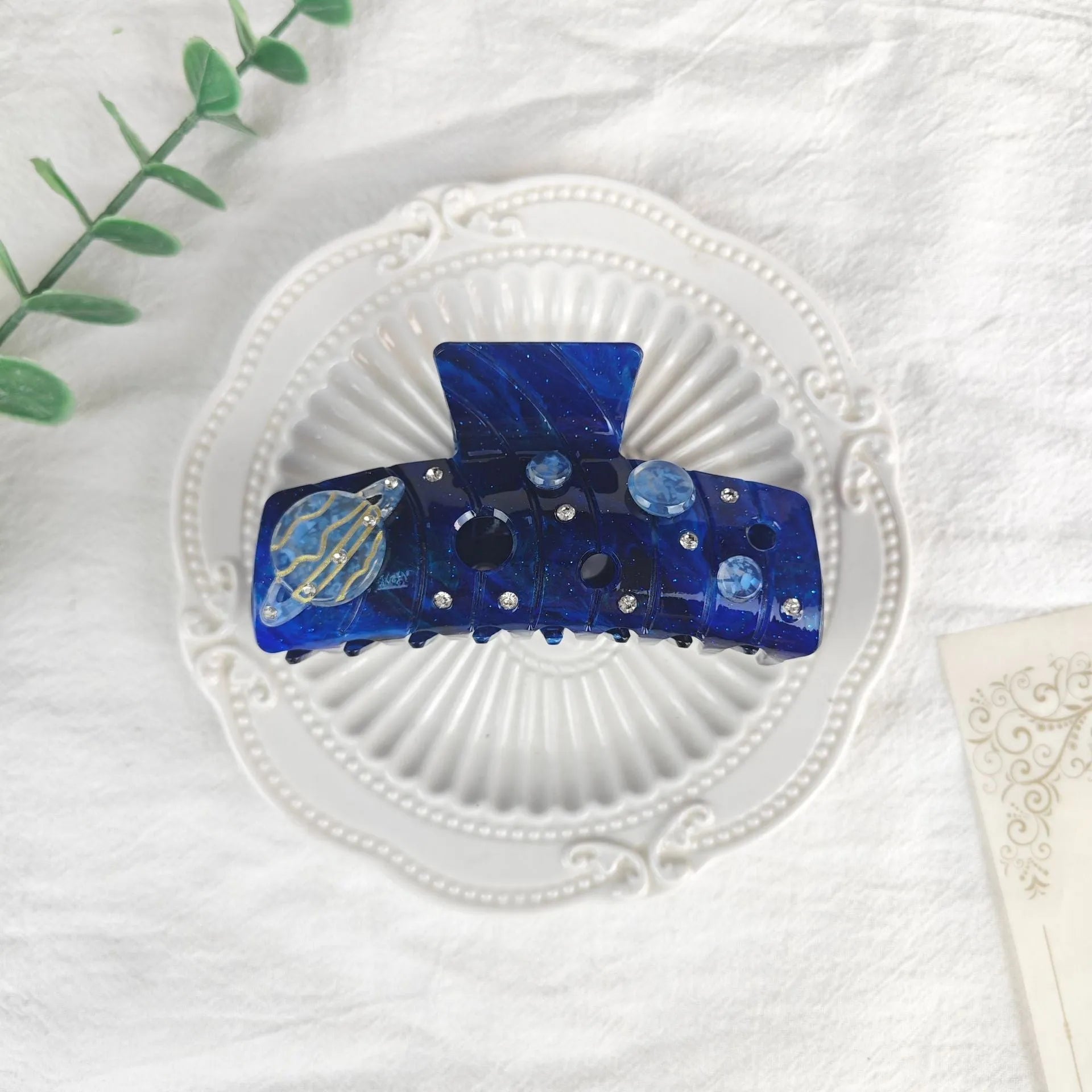 Oversized women's hair barrette with a starry sky pattern in sky blue.