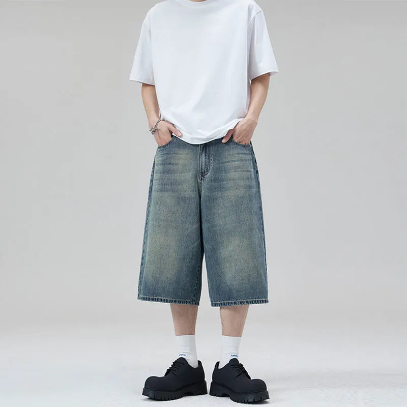 Men's straight leg cropped denim shorts in light blue, shown laid flat.