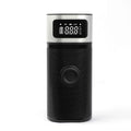 Black portable wireless car air pump with a digital display, inflation hose, and a set of nozzles on a black background.