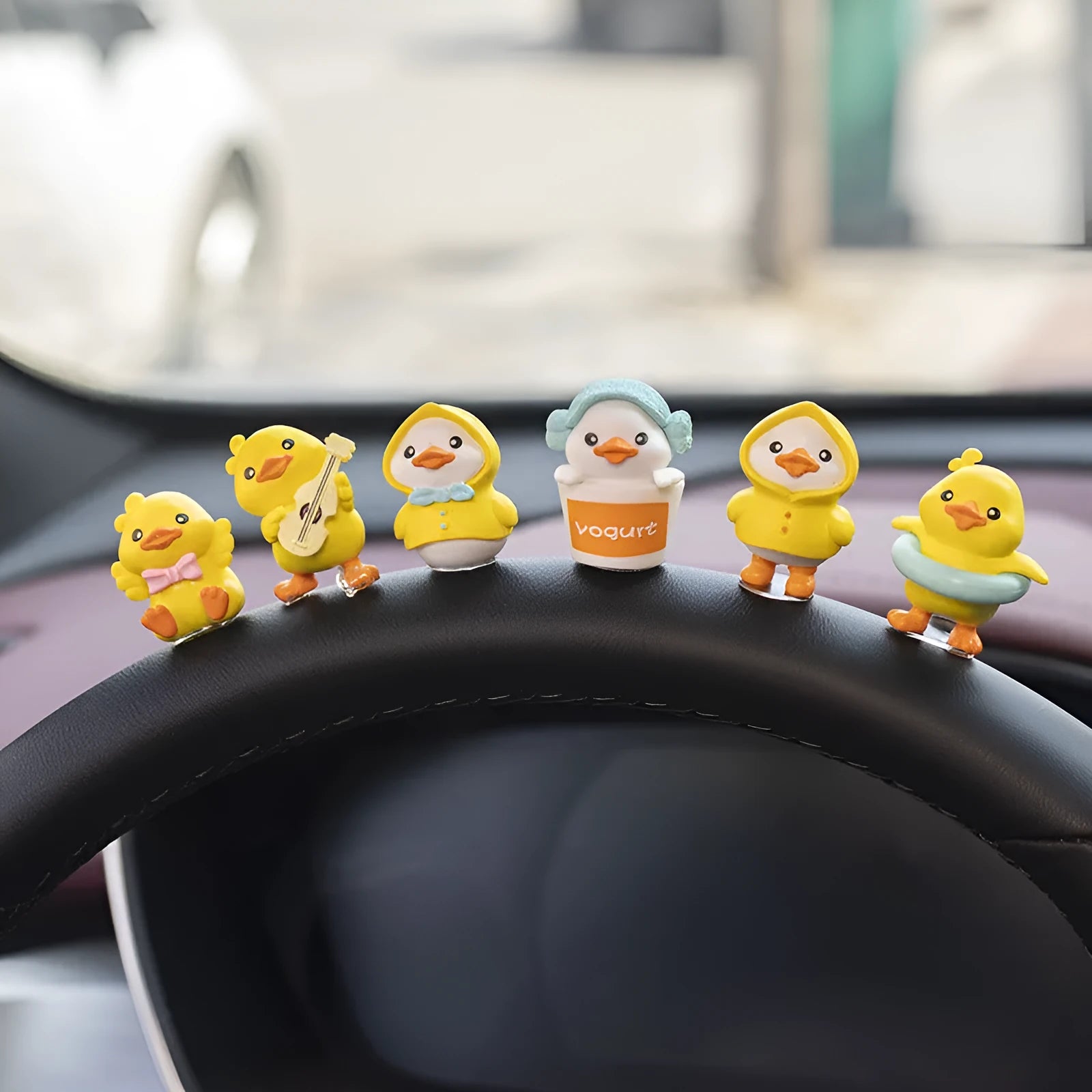 Set of six small PVC duckling ornaments and one larger Hello welcome sign for car interior decoration.