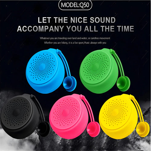 Bluetooth speaker with suction cup on a tiled wall, pink colour, dustproof design, USB charging port visible
