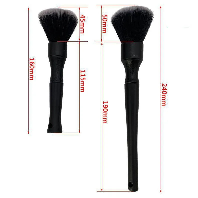 Black ultra-soft pig hair car detailing brush for interior cleaning on a car dashboard.
