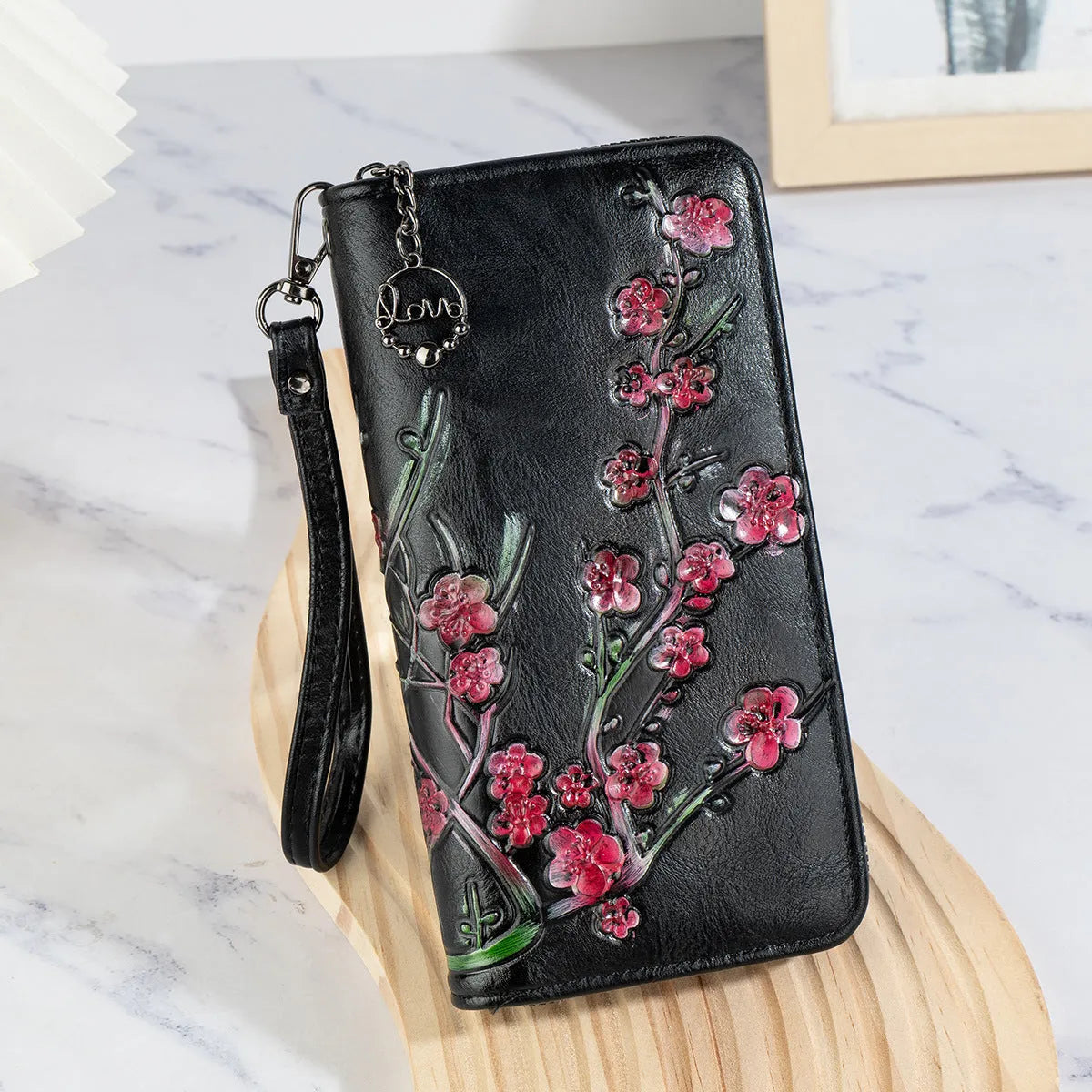 Retro brown handbag with embossed floral design and a large metal YKK zipper.
