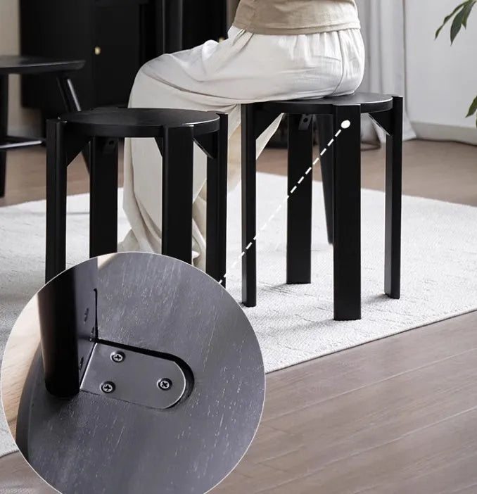 Stackable round iron dining stool in a modern style, shown in a choice of colours.