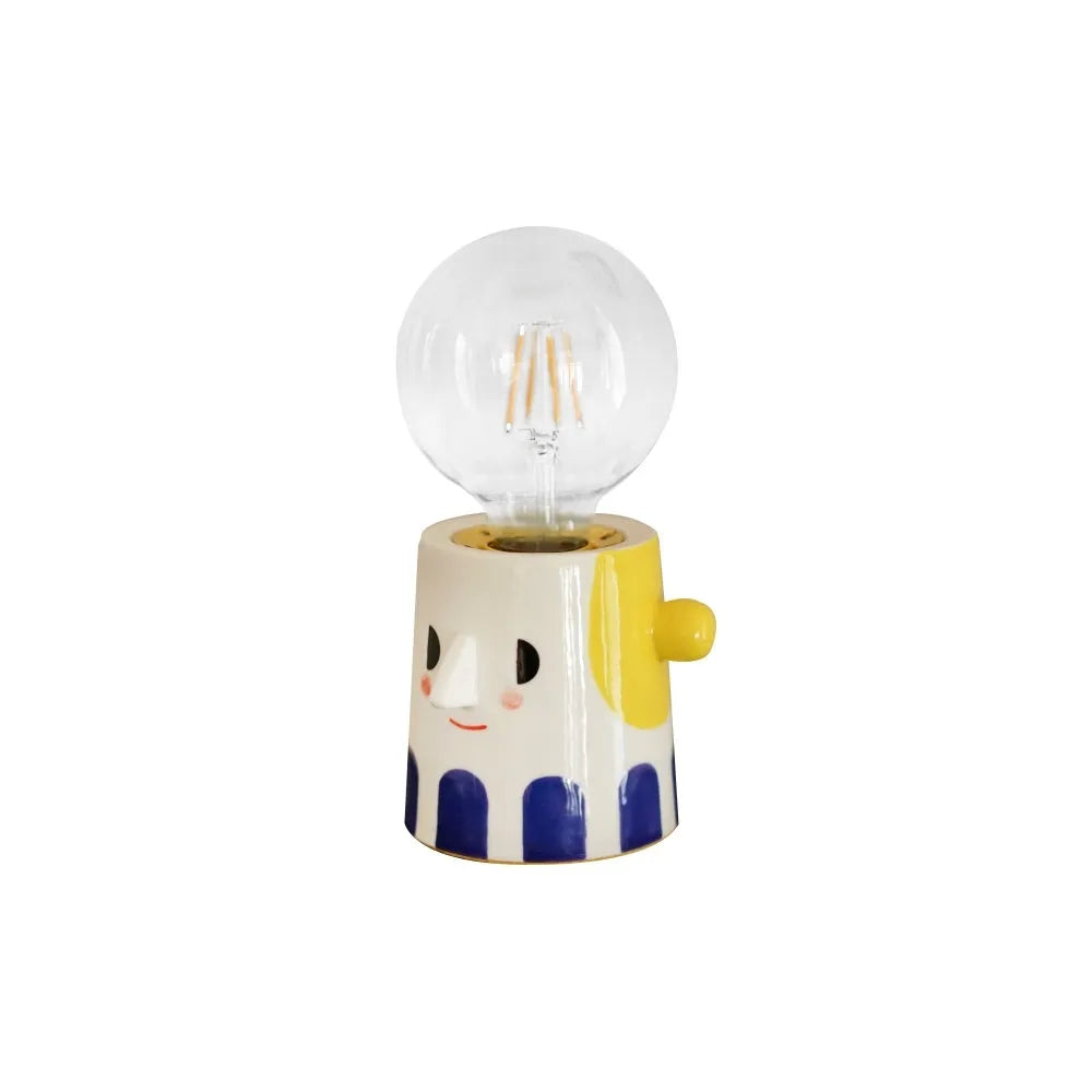 Handmade ceramic table lamp with a spherical ball headlight shade on a ceramic base.