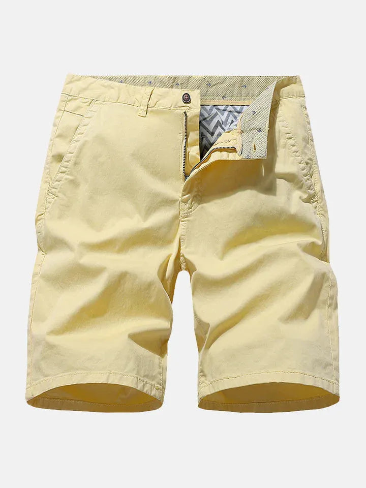 Man wearing blue denim casual shorts with no belt, straight leg, and loose workwear fit