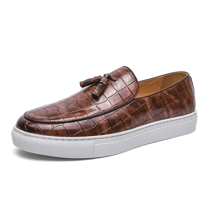 Men's brown artificial PU leather slip-on sneakers with a tassel detail on the round toe.
