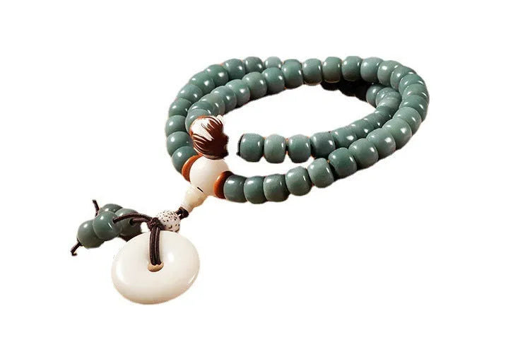 White jade and green sandalwood Bodhi seed bracelet showing either the safety buckle or lotus clasp fastening.
