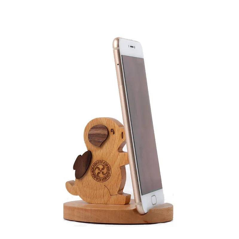 Decorative resin mobile phone stand in a choice of styles including animal figures and wood-effect designs.