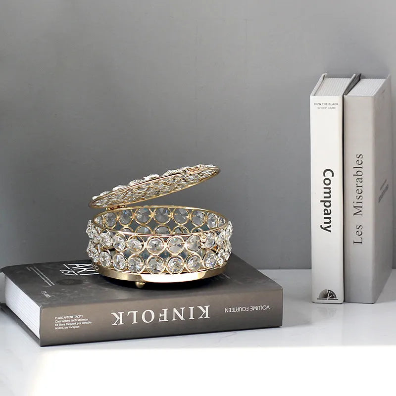 French gold iron frame crystal glass jewellery box with a metal lock closed.