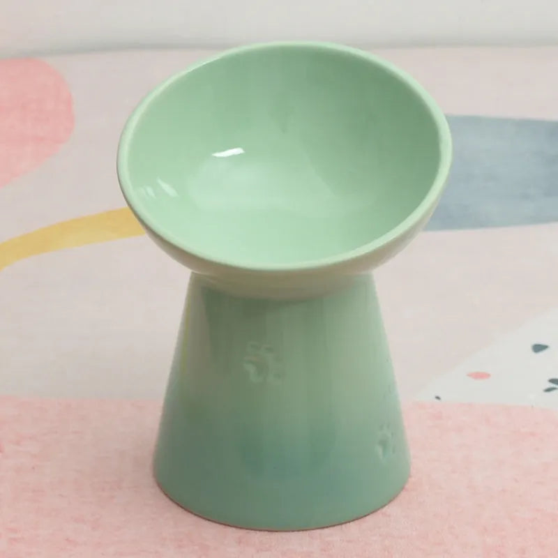 Black chin-high foot ceramic pet bowl for dogs and cats on a flat surface.