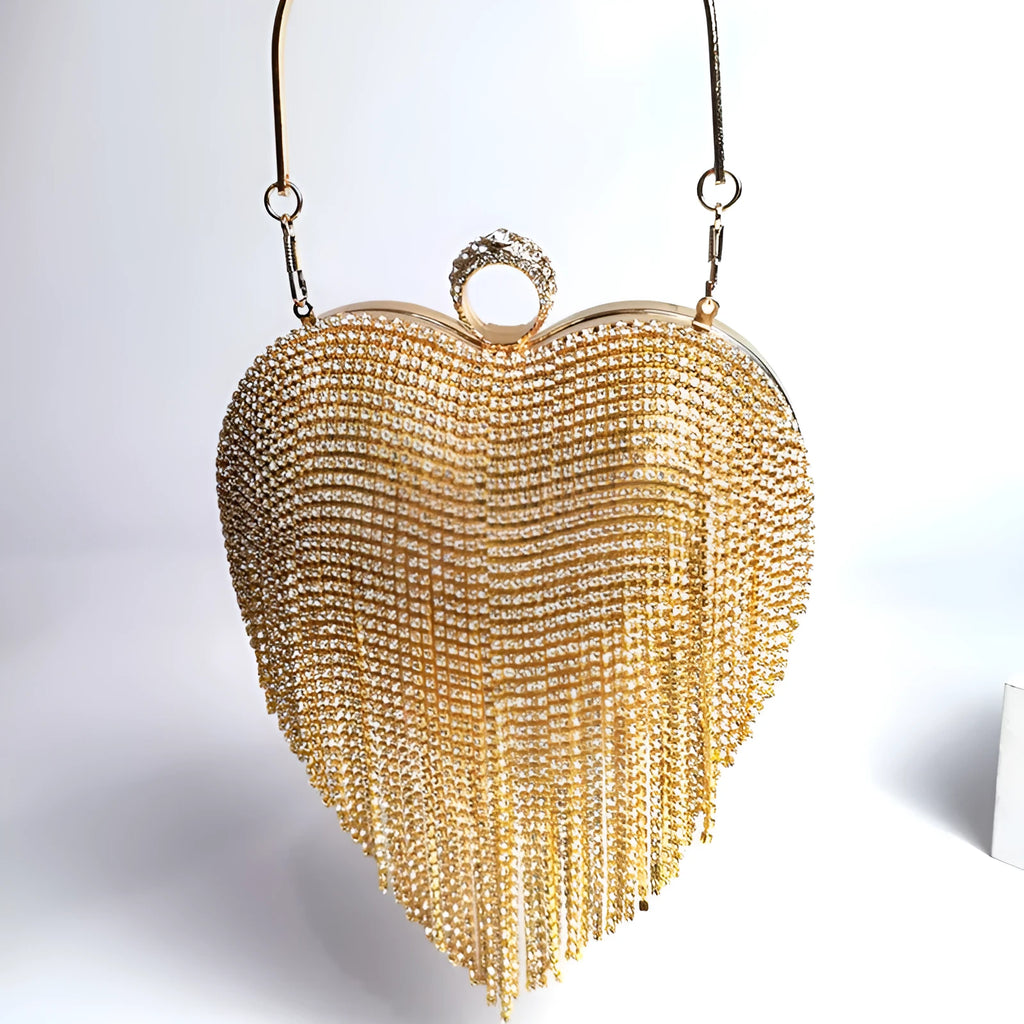 Women's heart-shaped metal dinner bag with tassel detail in black, gold, and silver options
