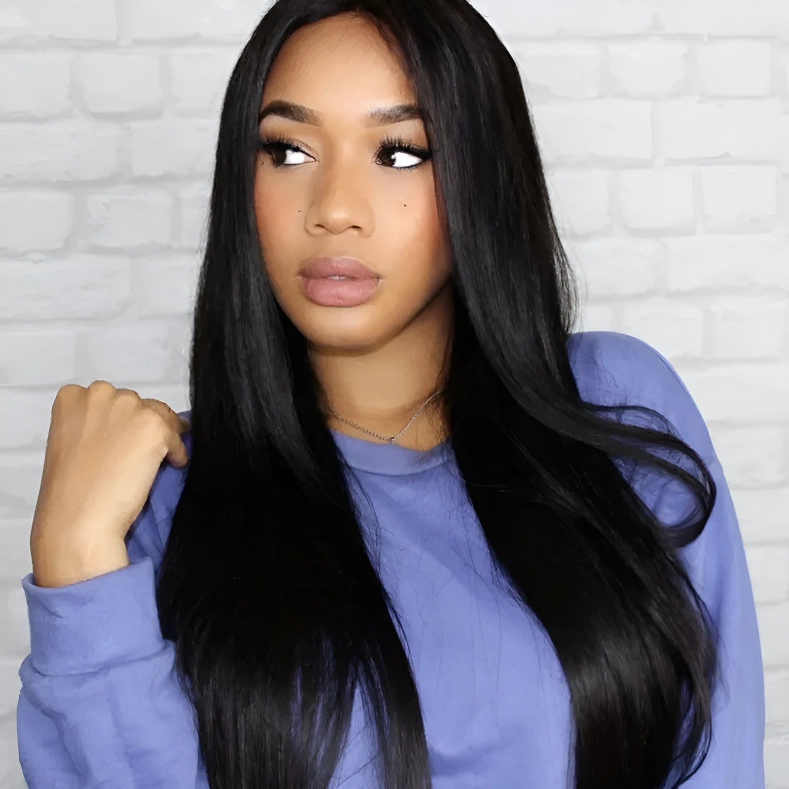 Long straight black synthetic wig with centre part and bangs on a model