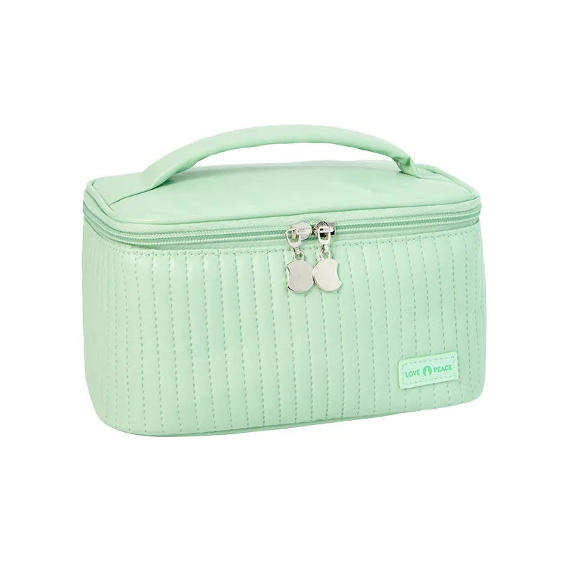 Open-top solid colour PU leather makeup bag in light blue on a white surface