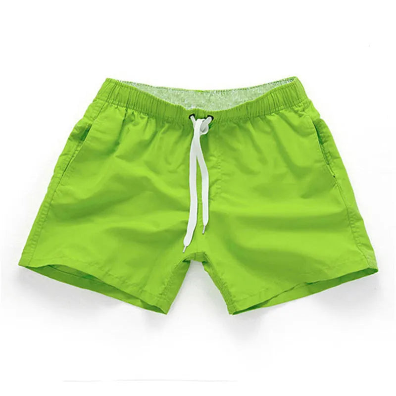 Men's straight-leg beach shorts in polyester fabric on a beach background