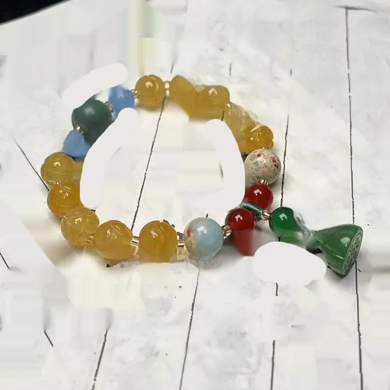 Carved Bodhi root bracelet with white jade, lotus, and pumpkin beads in various sizes.