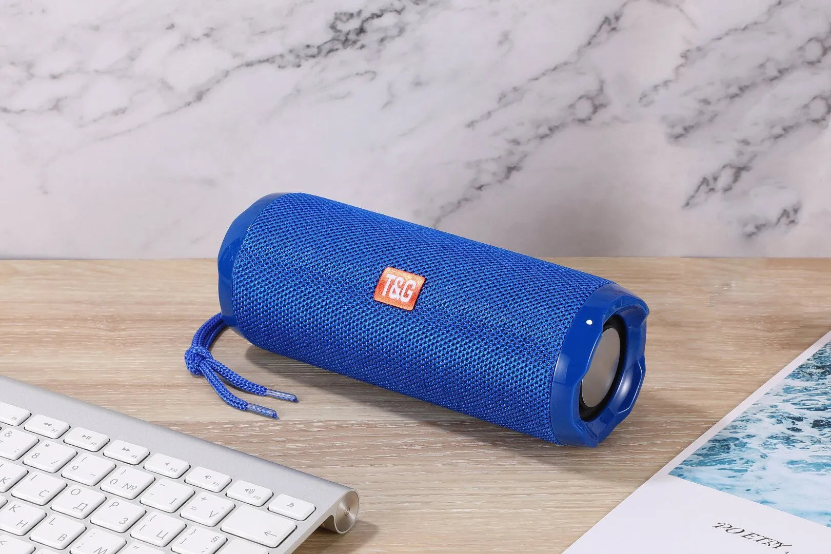 Blue portable Bluetooth speaker with a fabric card holder on the front