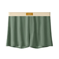 Men's solid colour loose ice silk underwear in a pack of three, shown in beige, black, and grey.