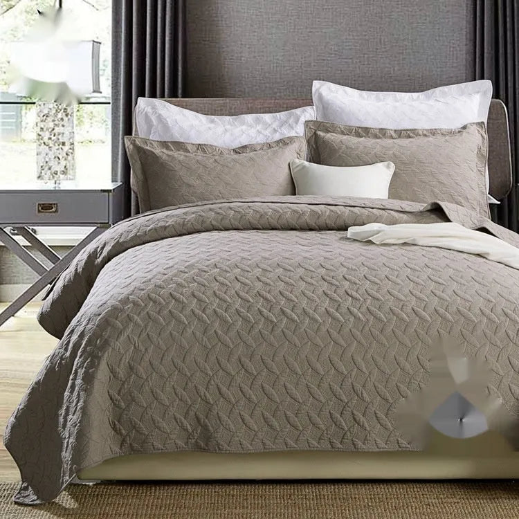 Pure cotton double-sided bed cover three-piece set in a plain colour laid on a bed.