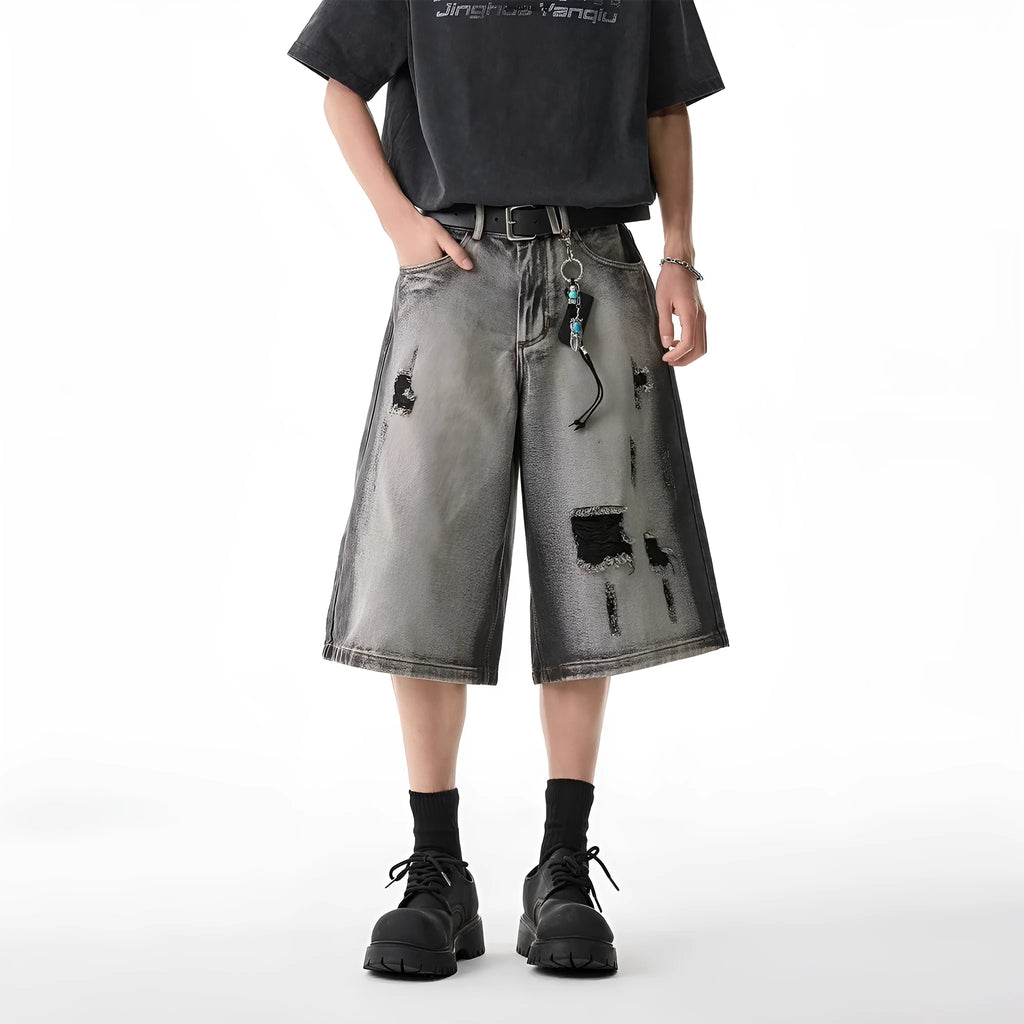 Grey water washed hole denim shorts with loose fit and cropped length on hanger